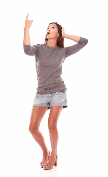 Brunette standing full length pointing up — Stock Photo, Image