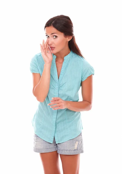 Cute stylish female in short jeans whispering — Stock Photo, Image