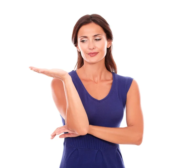 Attractive girl in purple dress holding palm up — Stock Photo, Image