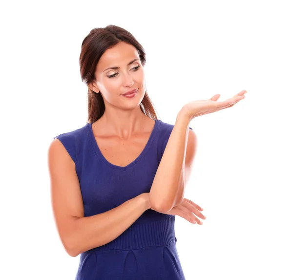 Attractive woman in purple dress holding palm up — Stock Photo, Image