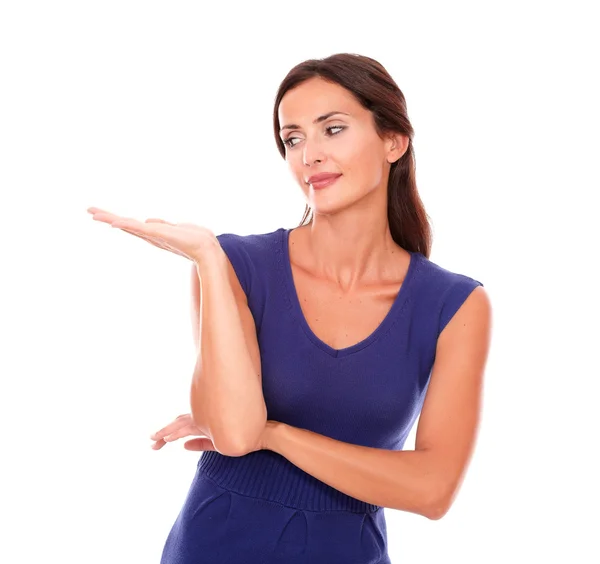 Attractive lady in purple dress holding palm up — Stock Photo, Image