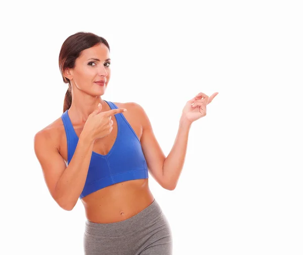 Brunette adult female pointing to her left — Stock Photo, Image