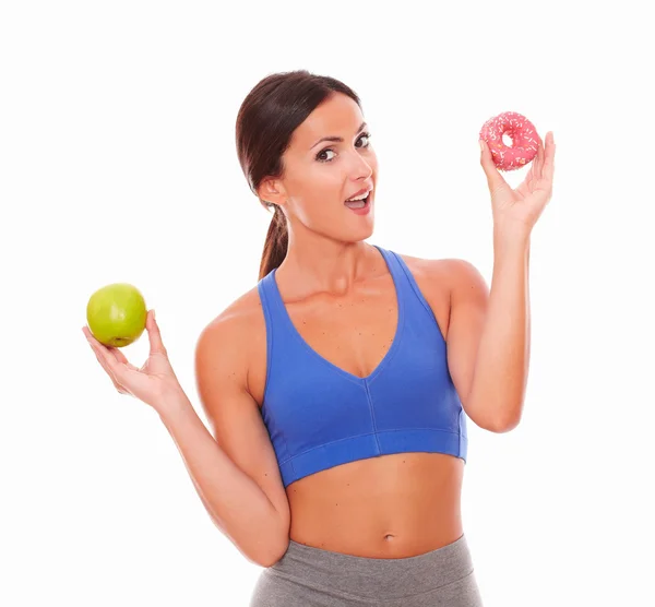 Sporty woman wanting to eat sugary cake — Stock Photo, Image