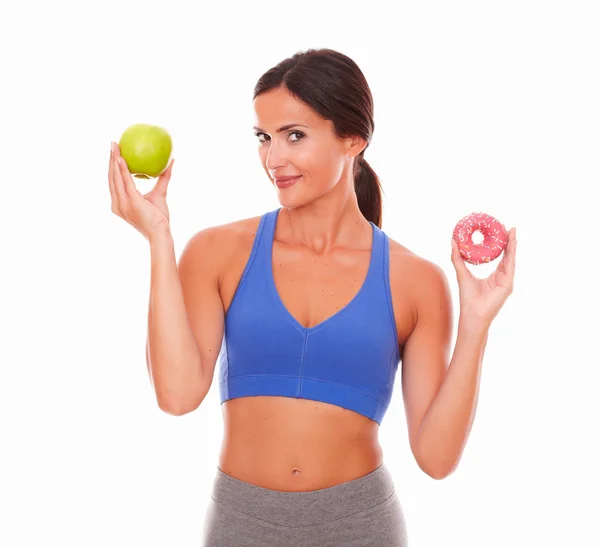 Woman in blue holding food looking at you — Stock Photo, Image