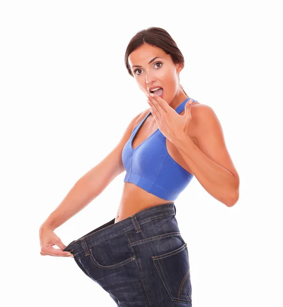 Sporty young woman looking surprised on body shape — Stock Photo, Image