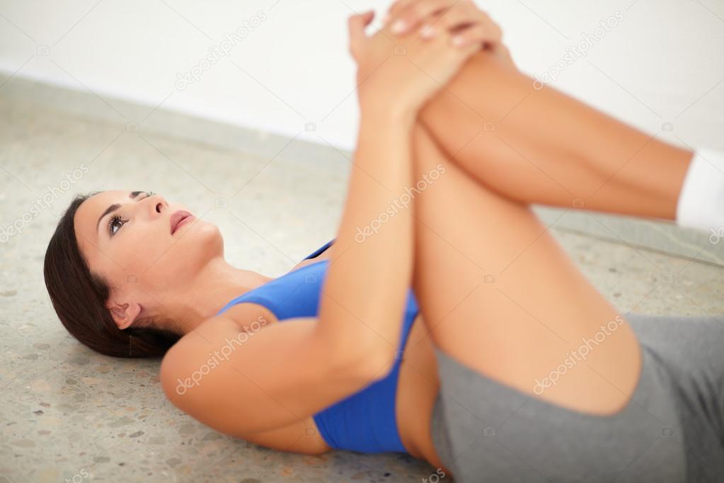 Brunette female exercising pilates for wellbeing
