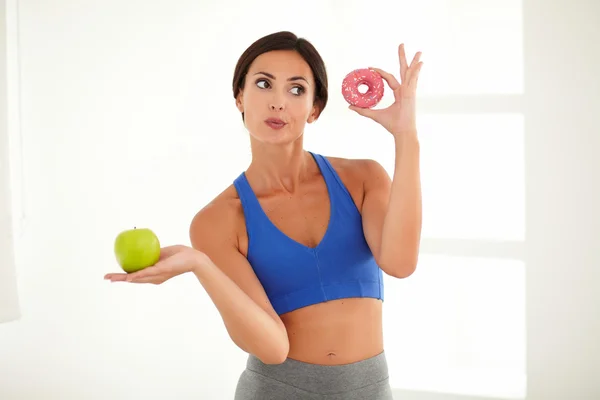 Dieting young lady choosing food for fitness — Stock Photo, Image