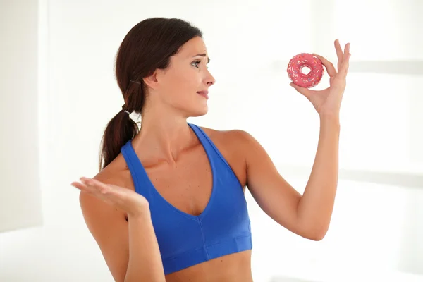 Hungry woman holding food of temptation — Stock Photo, Image