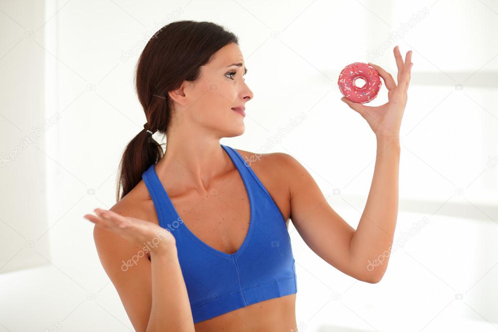 Hungry woman holding food of temptation