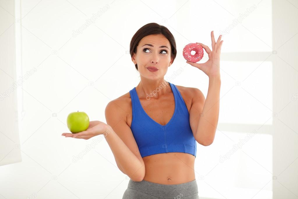 Slim energetic lady standing and holding food