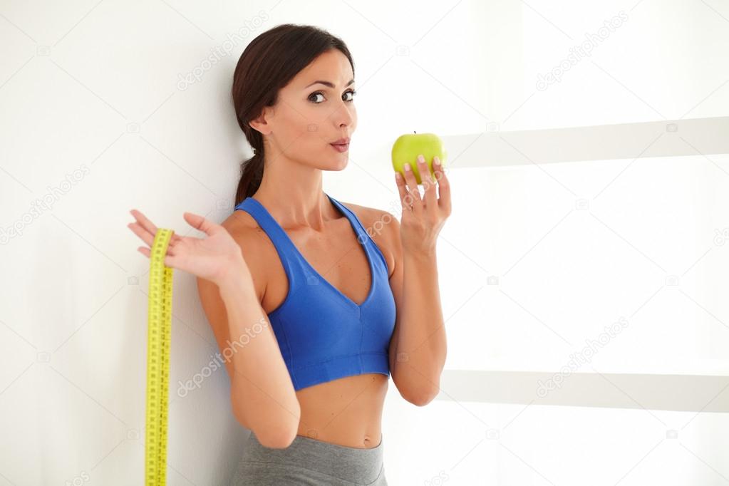 Health-conscious latin lady dieting on apple