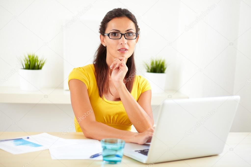 Smart businesswoman sitting in her room