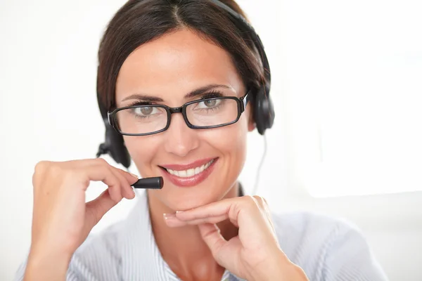 Pretty young secretary talking on her headset — Stock Photo, Image