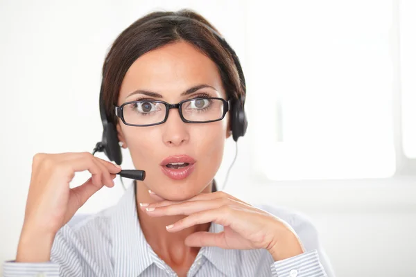 Professional employee speaking on the headphones — Stock Photo, Image