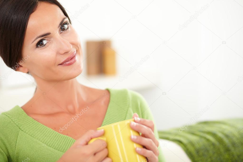 Woman with cup looking at the camera