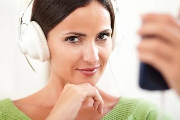Woman in headphones looking to camera — Stock Photo, Image