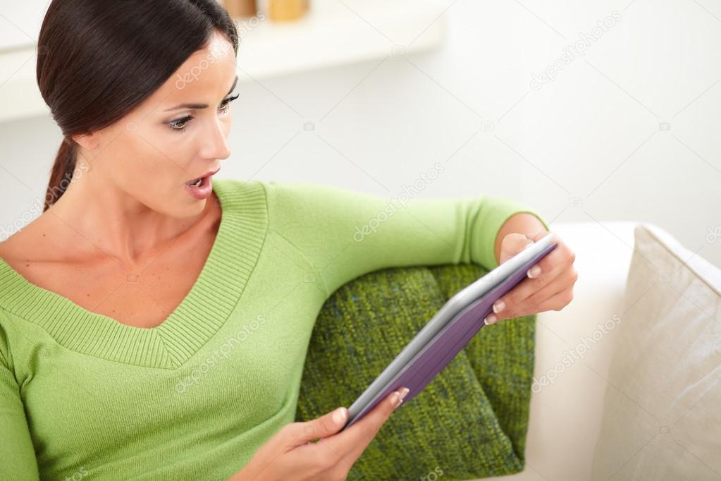 Surprised  woman holding a tablet