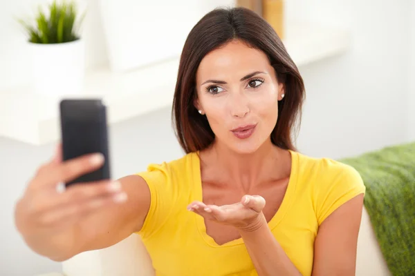 Relaxed young woman blowing a kiss — Stock Photo, Image