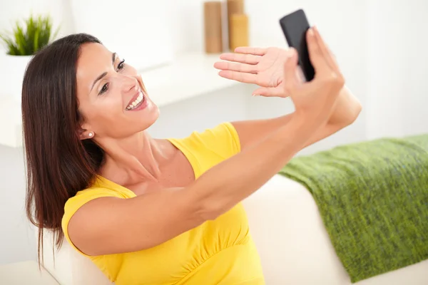 Beautiful woman taking photos with phone — Zdjęcie stockowe