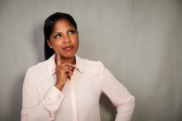 Young businesswoman planning with hand on chin — Stock Photo, Image