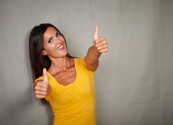 Happy woman showing thumbs up