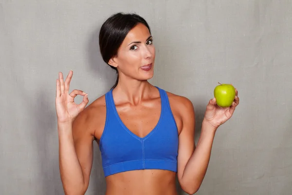 Woman with apple showing ok sign — Stock Photo, Image