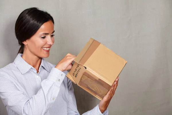 Happy businesswoman opening parcel — Stock Photo, Image