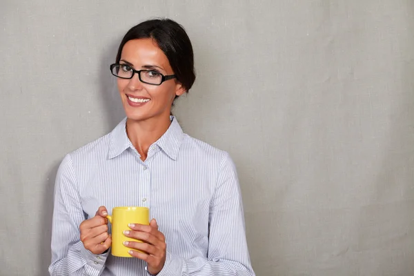 Happy lady with glasses holding mug — 스톡 사진