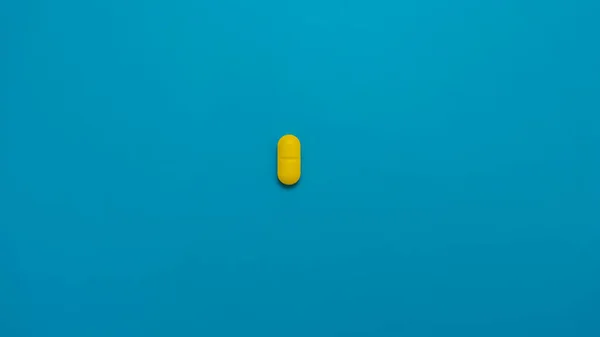 Yellow Vitamins Medicine Capsules Pills Isolated Blue Background Health Concept — Stock Photo, Image