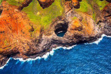 Aerial view of Na Pali coastline open ceiling cave from helicopt clipart