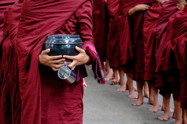 Detail of buddhist monks crowd and person holding a bowl and cup clipart