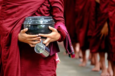 Detail of buddhist monks crowd and person holding a bowl and cup clipart