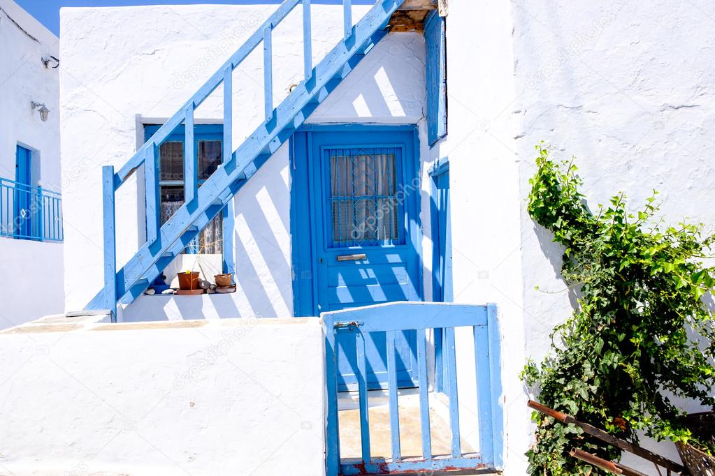 Typical traditional doors and windows in Greek white and blue st