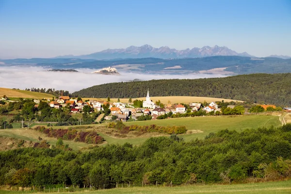 Scenic view of traditional village, castle, meadows and mountain — Stock Fotó
