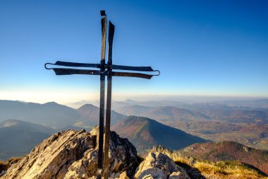 Scenic landscape view of mountain peak with metal cross, Slovaki clipart