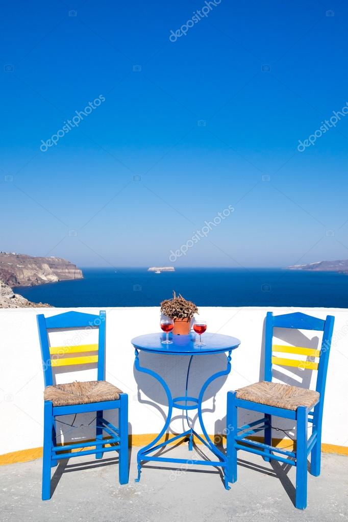 Blue chairs and table on a mediterranean balcony with nice view