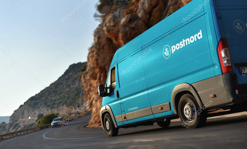 Kas / Turkey - 10.08.18: PostNord AB is the name of the holding company of the two merged postal companies Posten AB and Post Danmark delivery van speeding by countryside