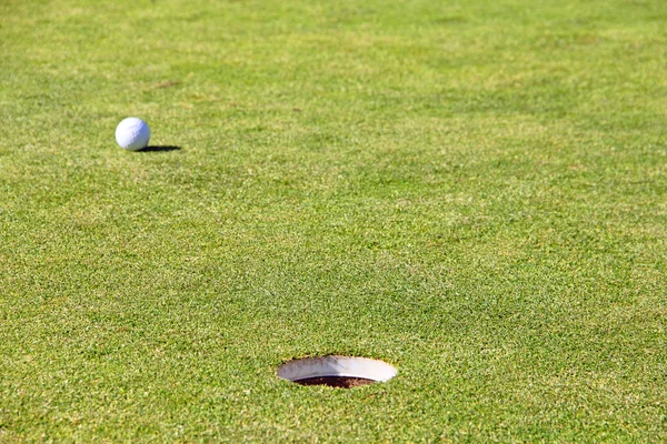 Golf ball on lip of cup — Stok fotoğraf