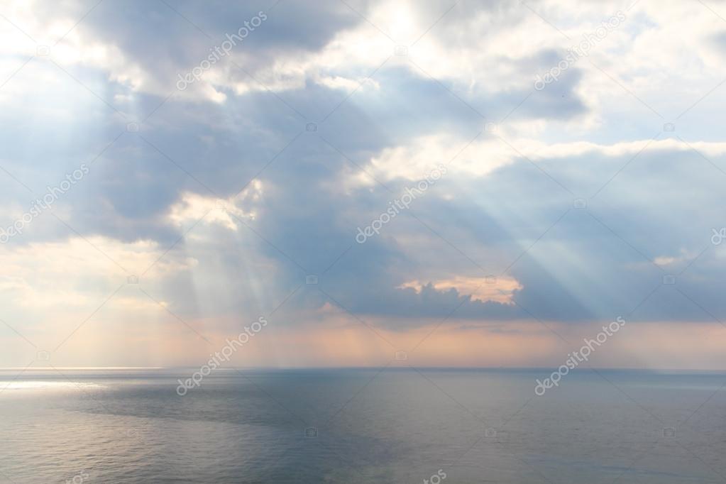 Light rays through the clouds over sea