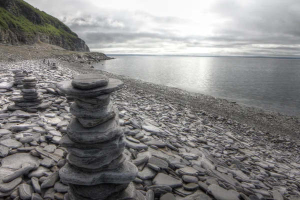 Stack of stones on fjord background — Stock Photo, Image