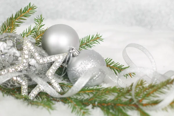 Christmas balls and green fir branch on snow — Stock Photo, Image