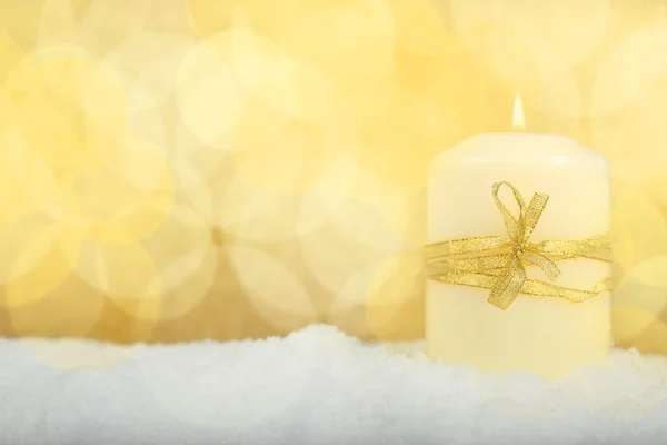 Christmas candle on snow — Stock Photo, Image