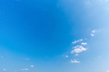 Açık mavi gökyüzü arkaplanı, arka planda bulutlar.