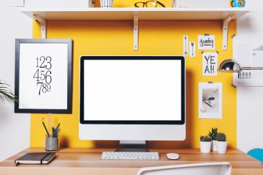 Modern creative workspace on yellow wall.  clipart
