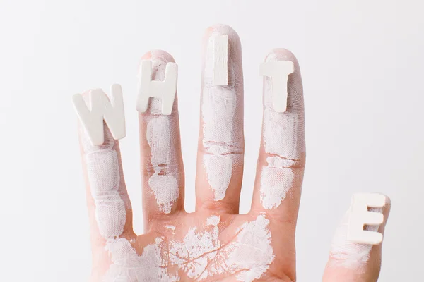 The word white on the fingers of a man over white background. — Stock Photo, Image