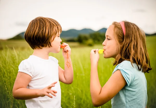 Children blowing whistle — Stock Photo, Image