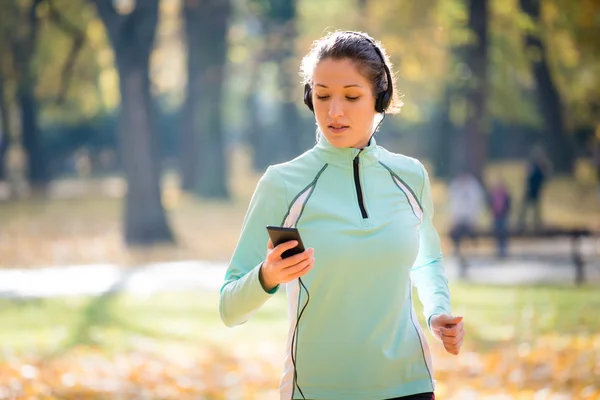 Kvinnan jogging och lyssna musik — Stockfoto