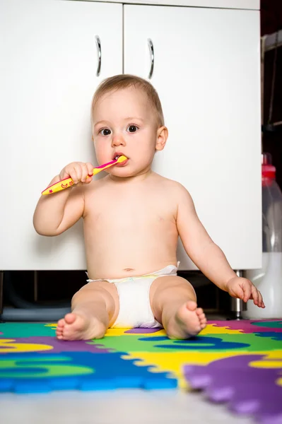 Baby cleaning teeth in bathroom — Stock Photo, Image