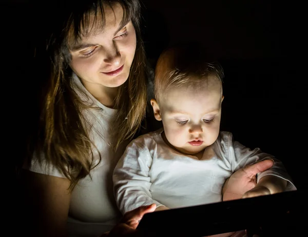 Modern world - mother, baby and tablet — Stock Photo, Image