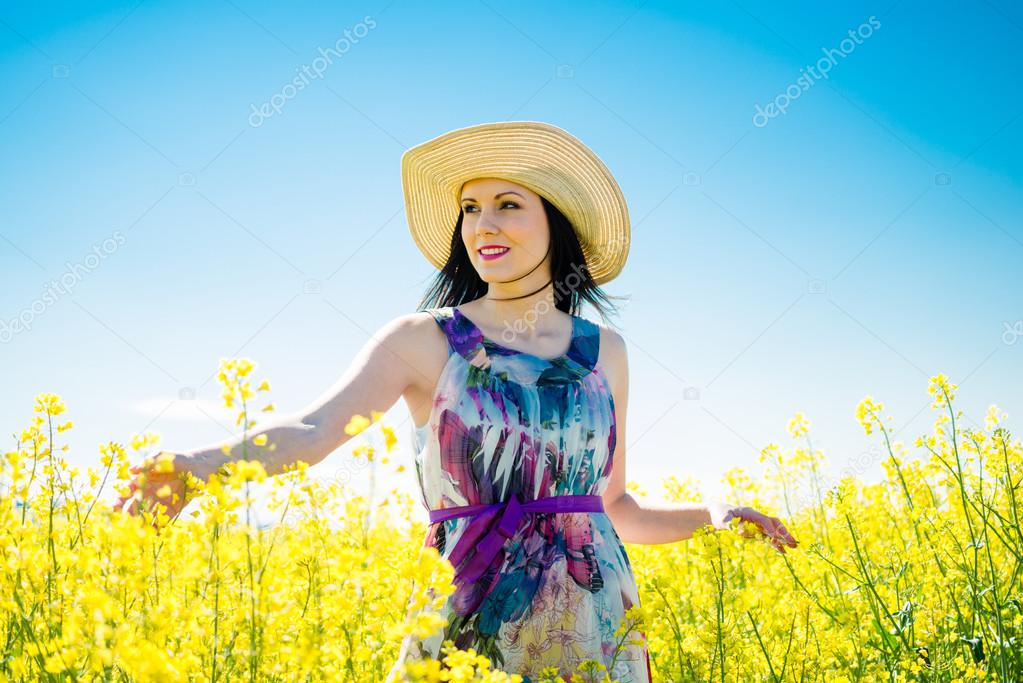 Young woman in rapeseed field